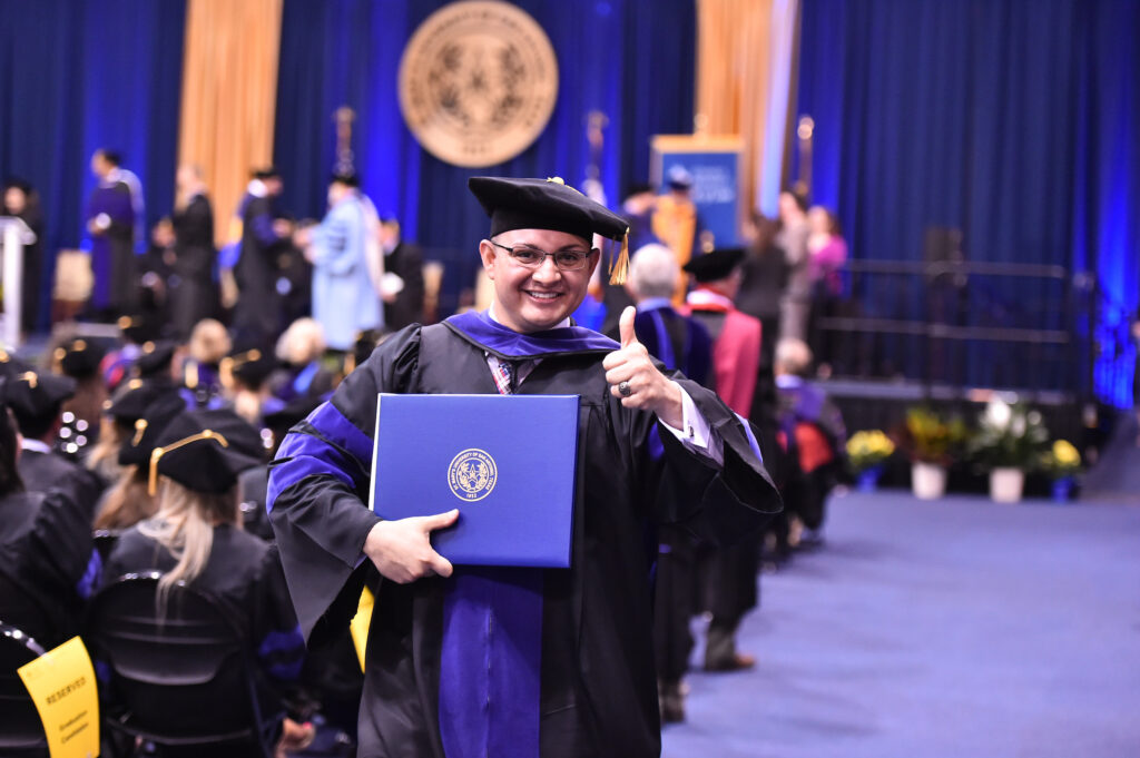 Student standing at graduation