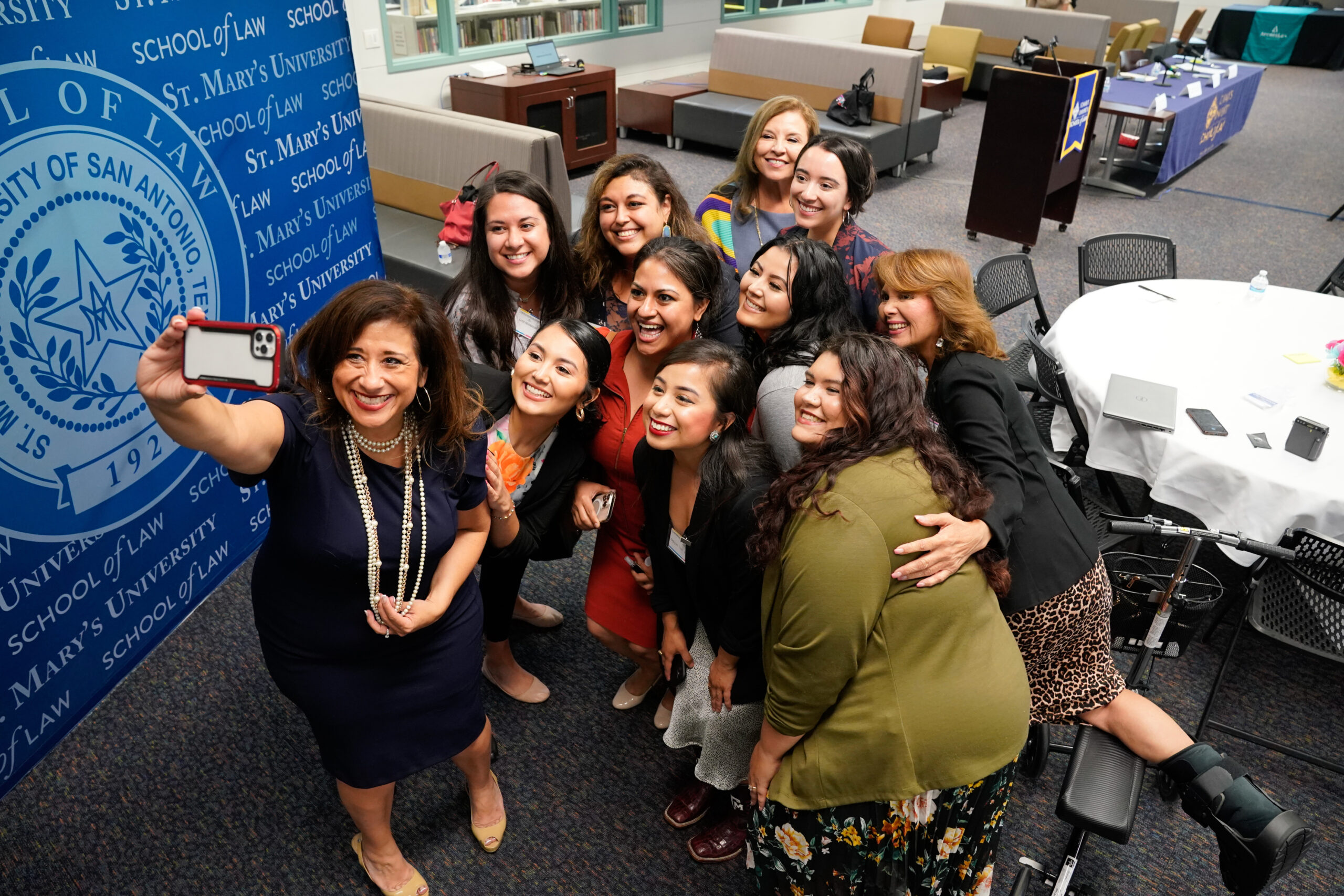 Photo of Attendees pose for a selfie with Chief Justice Dori Contreras of the Texas Thirteenth Court of Appeals and the Hon. Antonia (Toni) Arteaga (J.D. ’00), 57th District Court of Bexar County, at the 2022 Lawtina Network Summit.