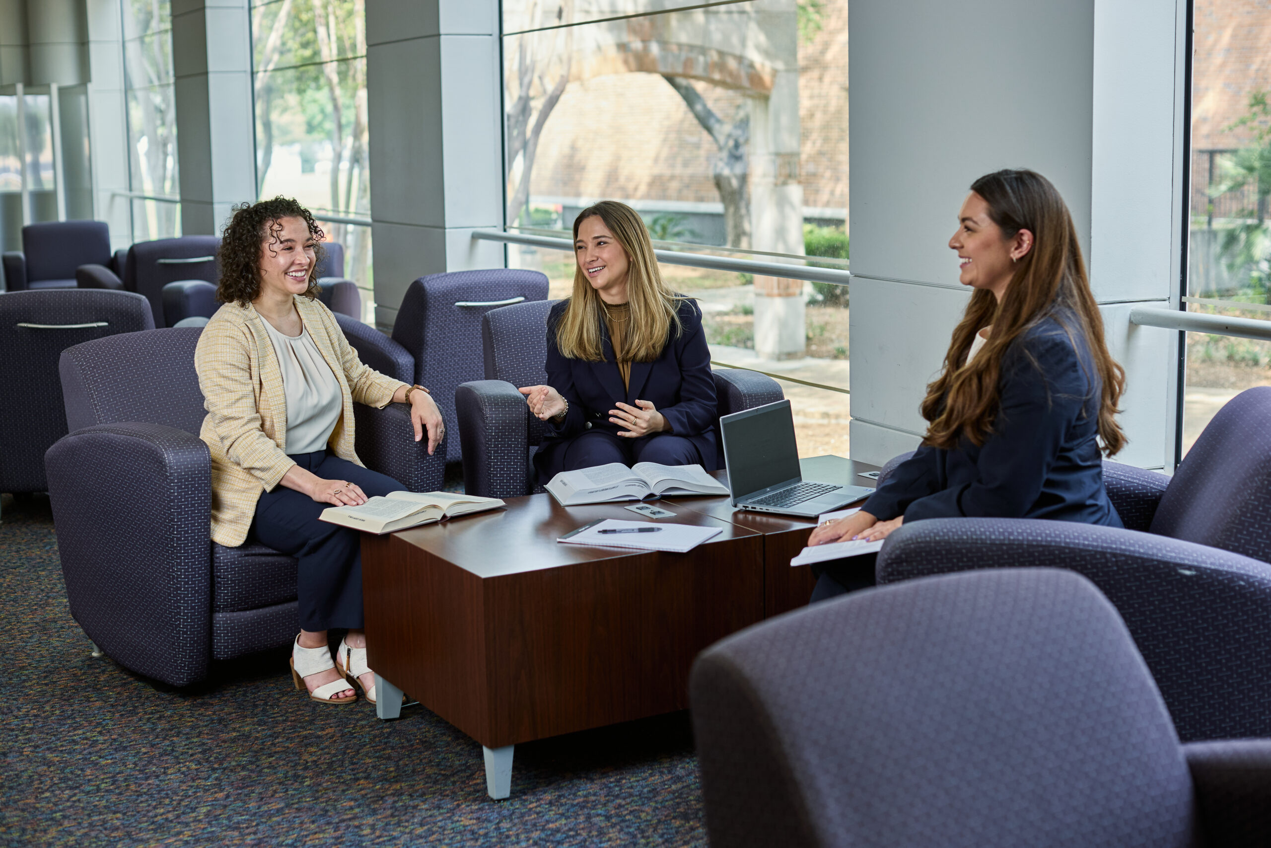 Three females work together in the law library.