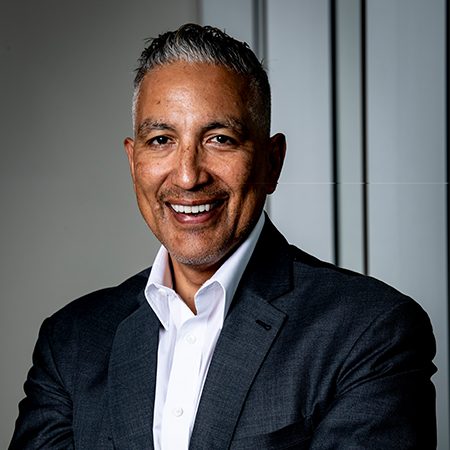 Bobby Perez in dark jacket and white shirt