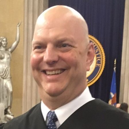 Portrait of Stuart Alcorn in black robe in courtroom